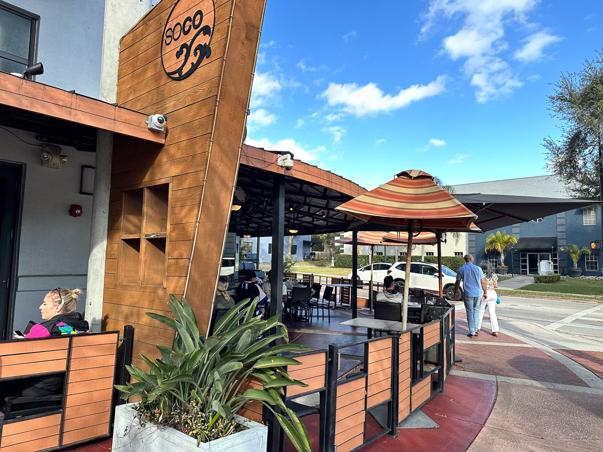 front of soco restaurant with sign